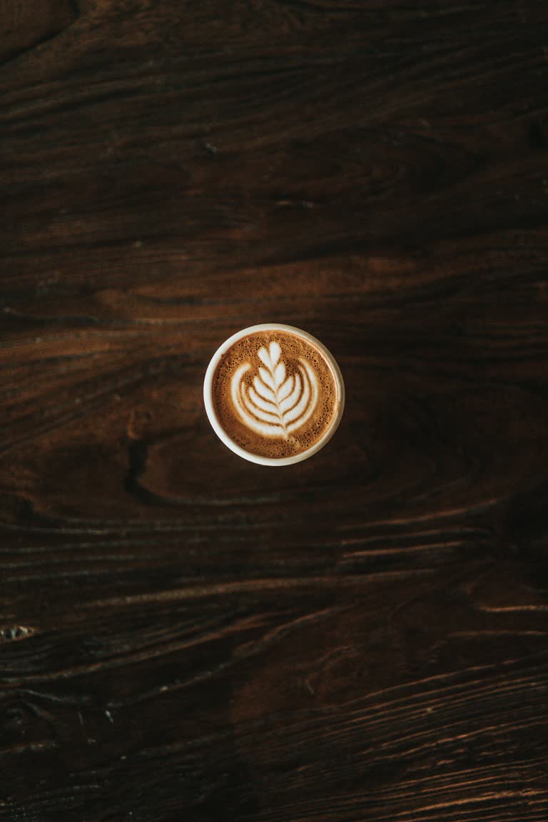 木桌上一杯咖啡的俯视图
