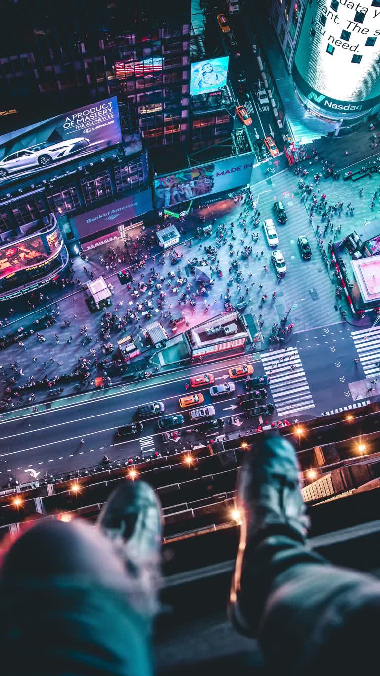 有一个人站在壁架上,俯视着一条繁忙的街道
