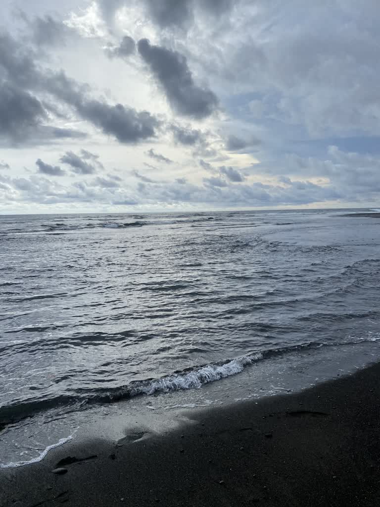 有一个人拿着冲浪板在沙滩上行走