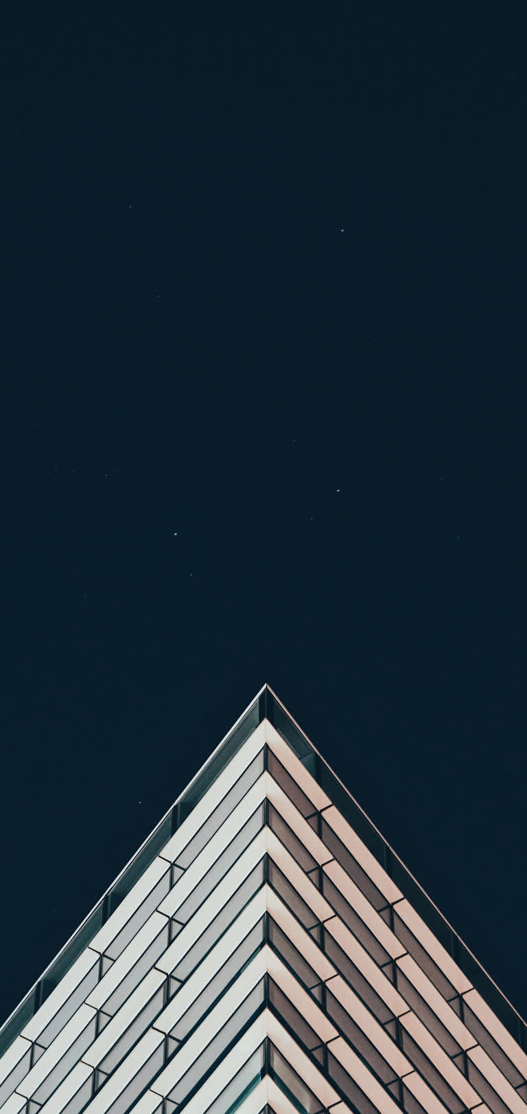 有一架飞机在天空中飞过一座建筑物