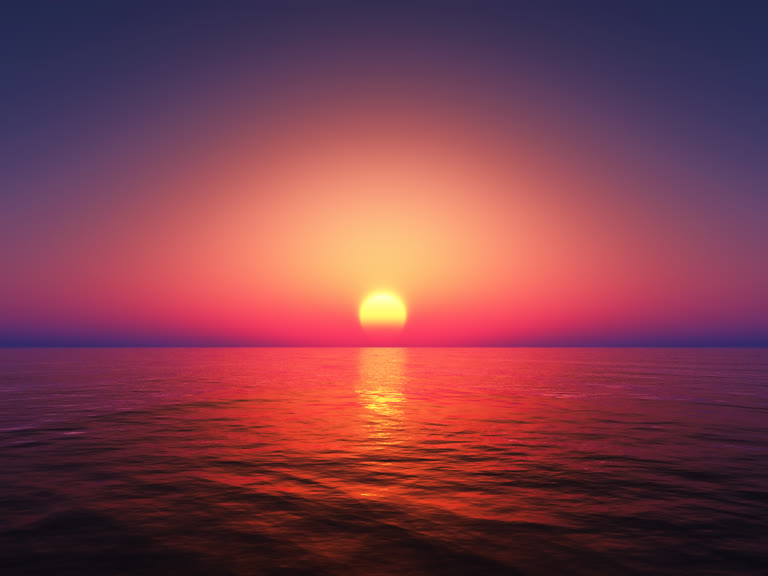 太阳落在平静海洋的地平线上