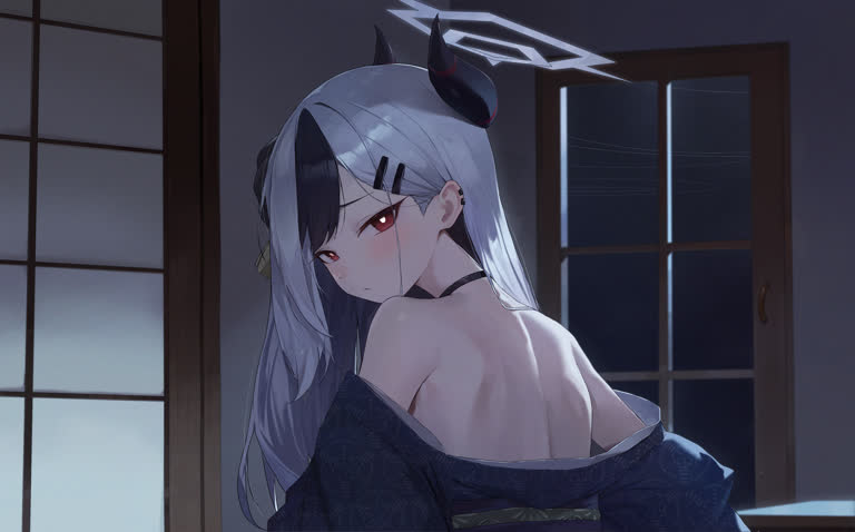 有一个女人坐在房间的床上