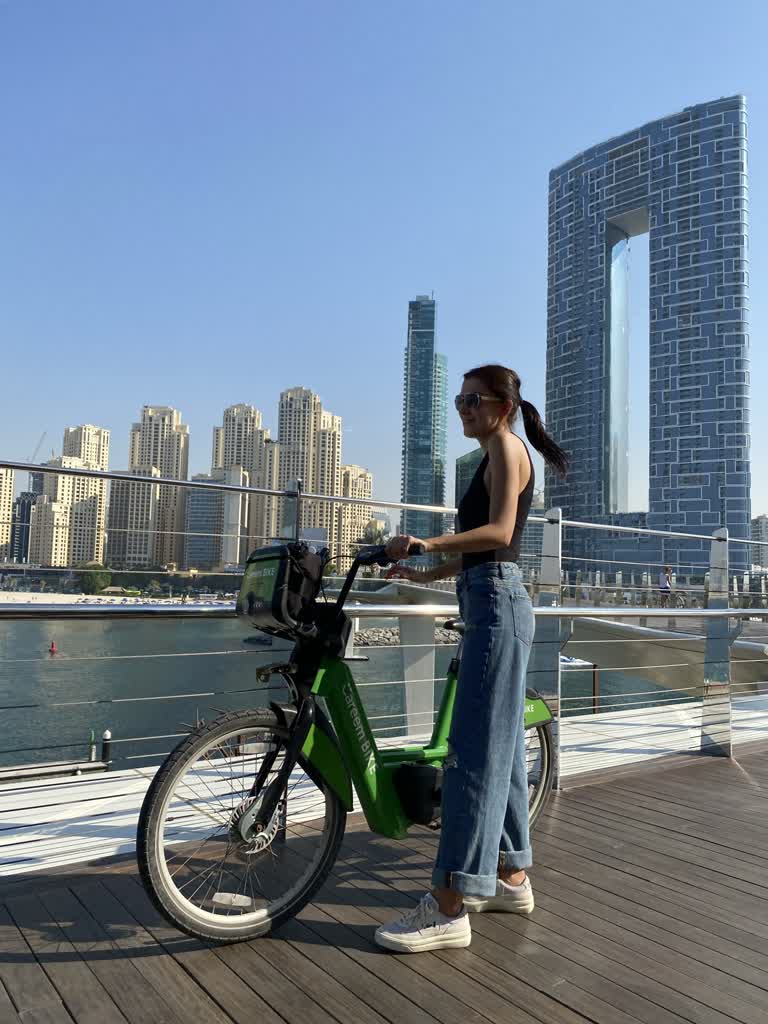 有一个女人站在一辆自行车旁边