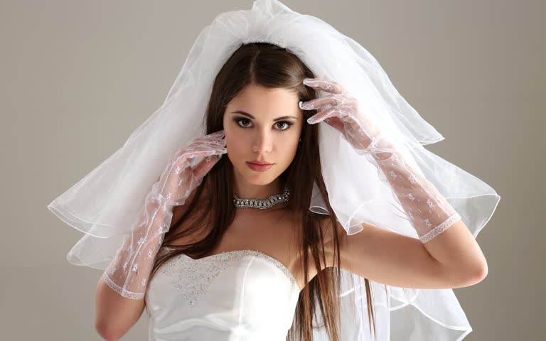 有一个穿着婚纱的女人头上戴着面纱